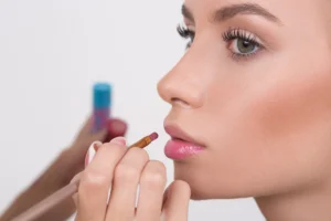 bigstock-makeup-artist-applies-lipstick-96438923